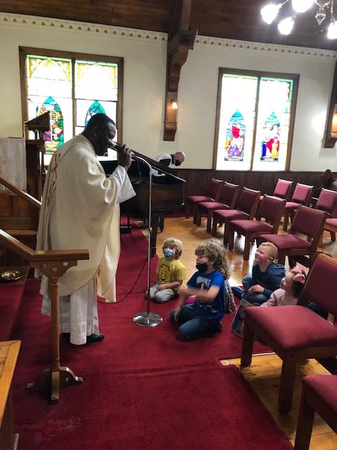 Father Alvardo speaking to the Sunday School children